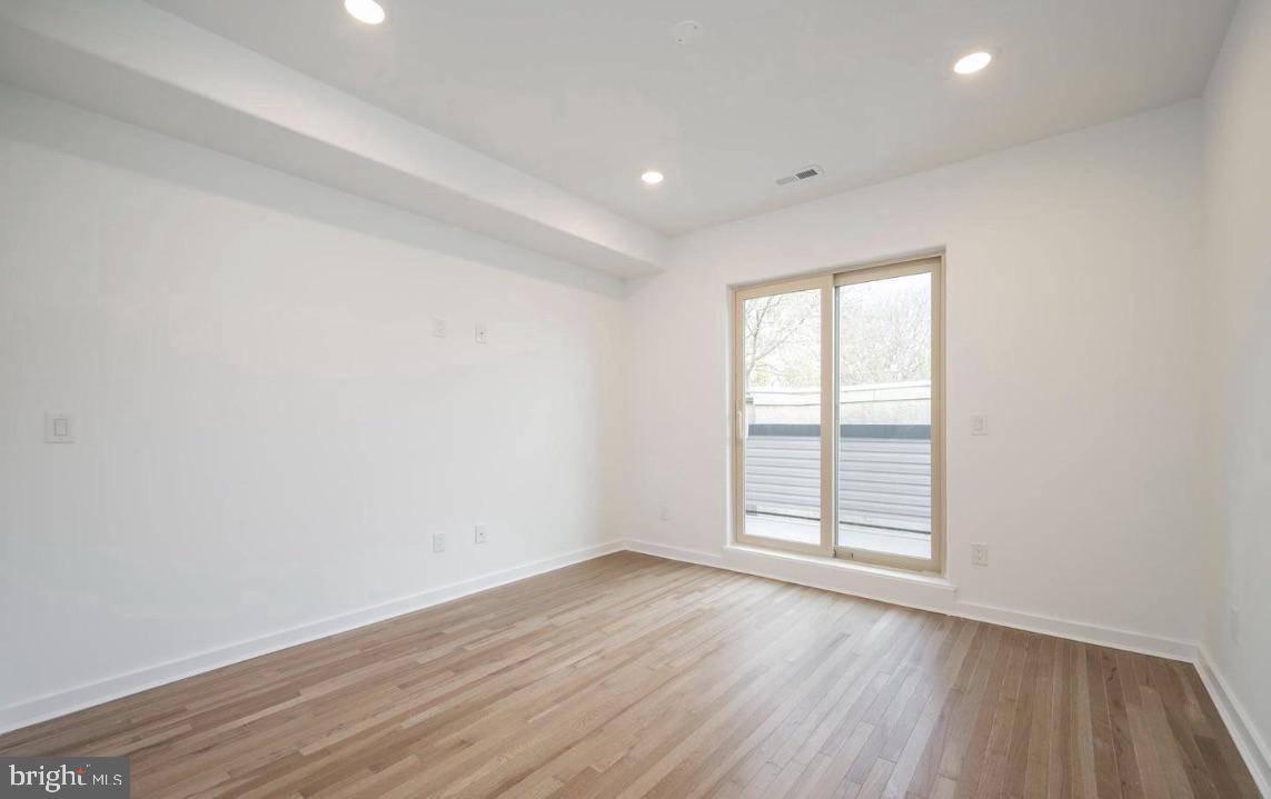 727 North 39th Street, Unit 2 Philadelphia, PA 19104 - Photo 12 of 15 an empty room with wooden floor and windows