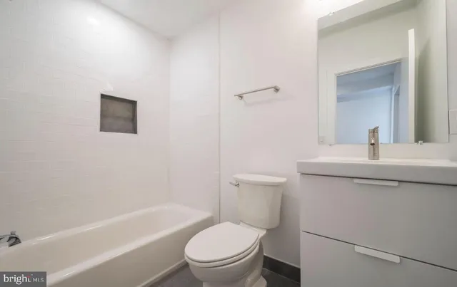 a bathroom with a toilet a sink and a bathtub