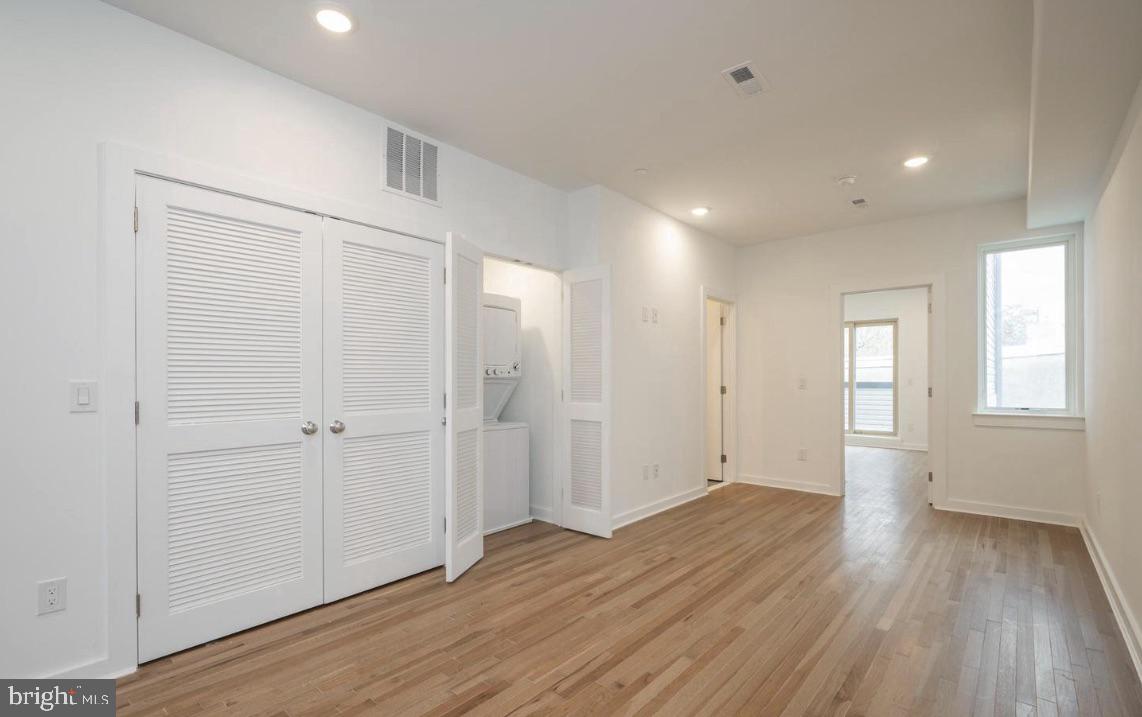 727 North 39th Street, Unit 2 Philadelphia, PA 19104 - Photo 5 of 15 an empty room with wooden floor and windows