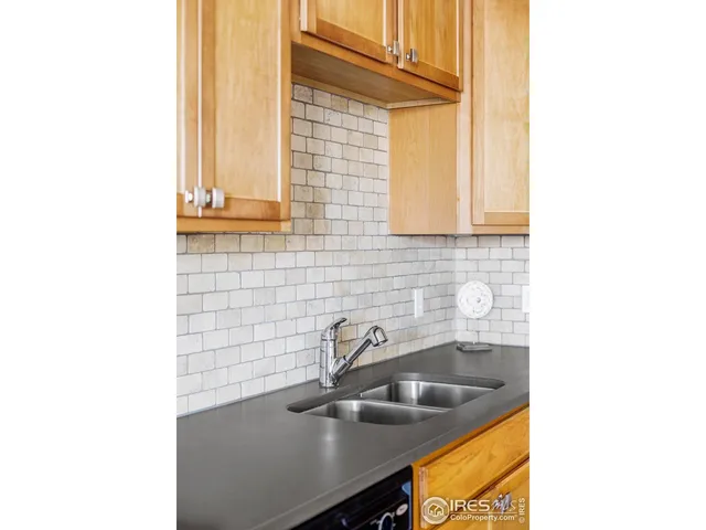 a kitchen with stainless steel appliances granite countertop a refrigerator a stove and a sink