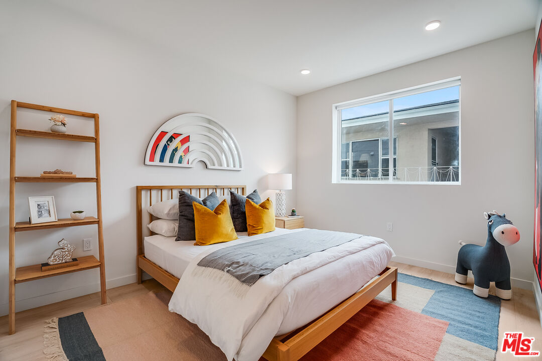 1021 South Shenandoah Street, Unit 501 Los Angeles, CA 90035 - Photo 11 of 19 a bedroom with a bed and dresser