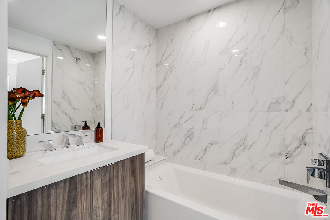 1021 South Shenandoah Street, Unit 501 Los Angeles, CA 90035 - Photo 12 of 19 a bathroom with a sink and a bathtub