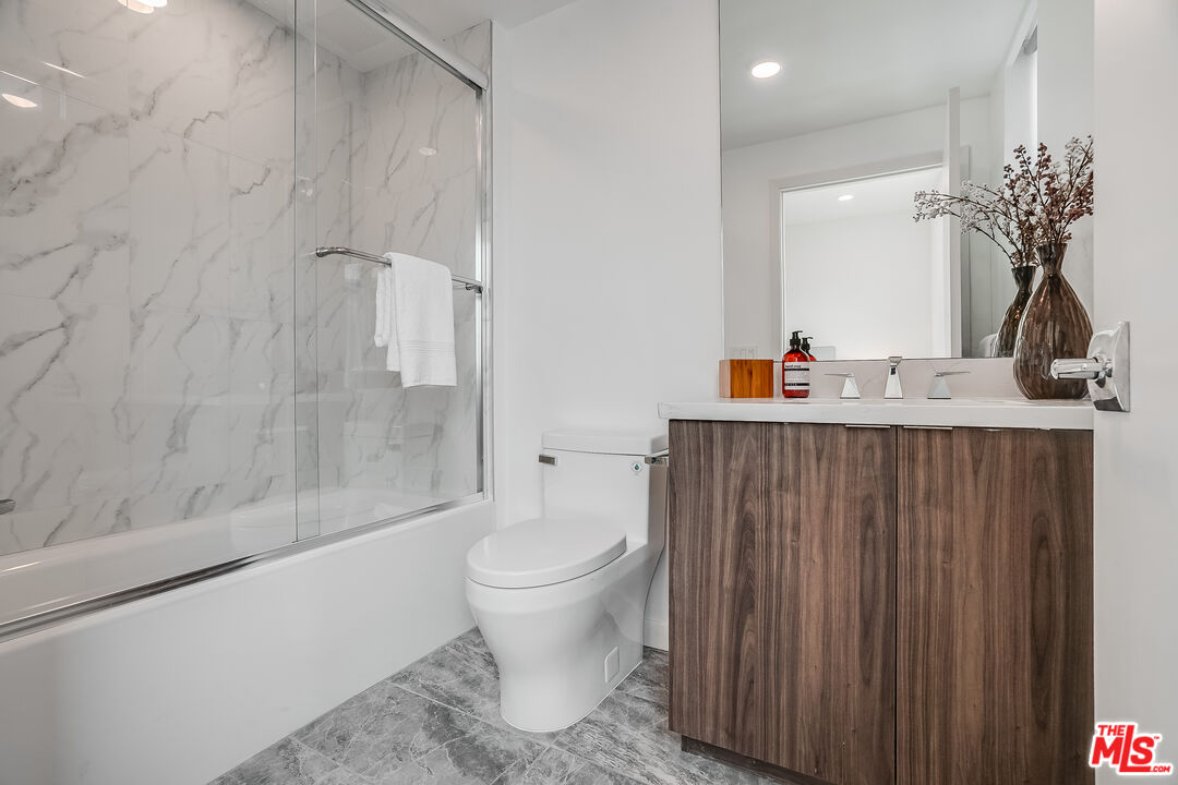 1021 South Shenandoah Street, Unit 501 Los Angeles, CA 90035 - Photo 15 of 19 a bathroom with a sink toilet and shower