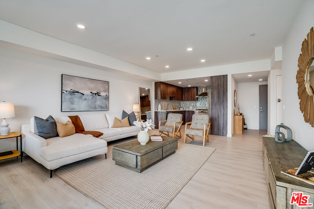 1021 South Shenandoah Street, Unit 501 Los Angeles, CA 90035 - Photo 3 of 19 a living room with furniture and a flat screen tv