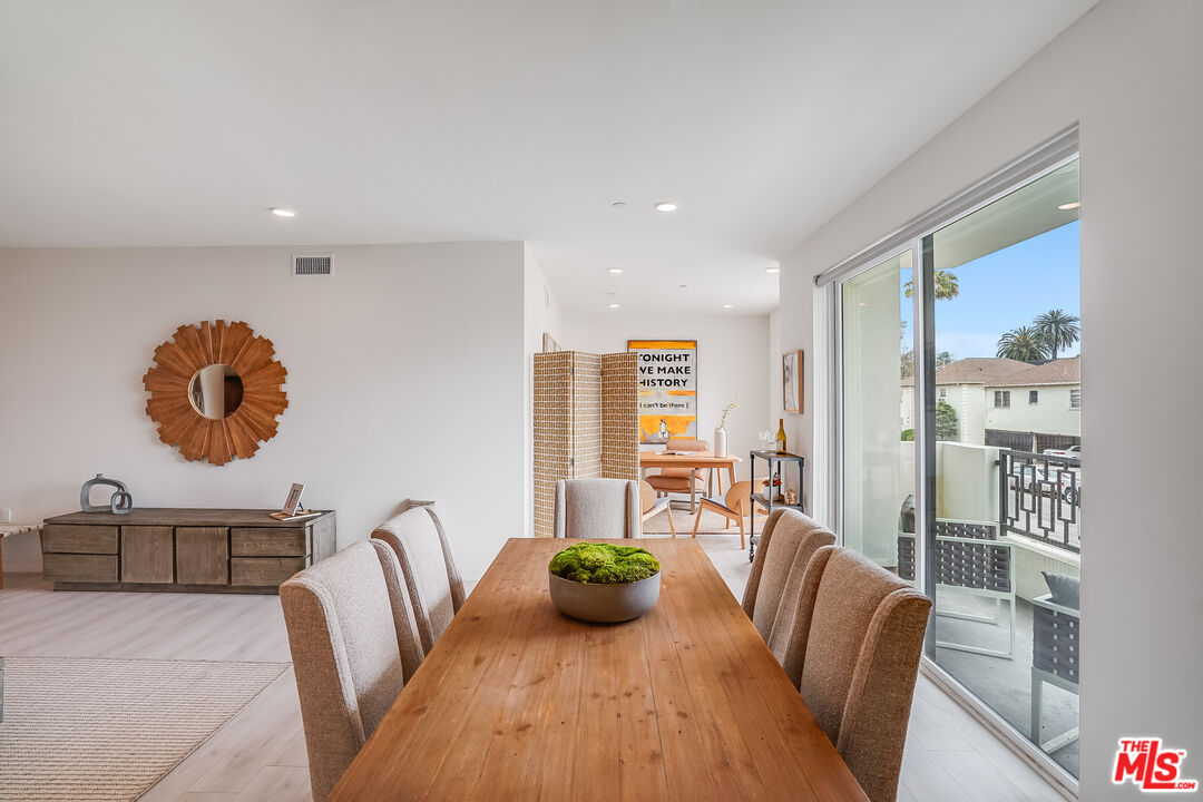 1021 South Shenandoah Street, Unit 501 Los Angeles, CA 90035 - Photo 5 of 19 a view of a dining room with furniture window and wooden floor