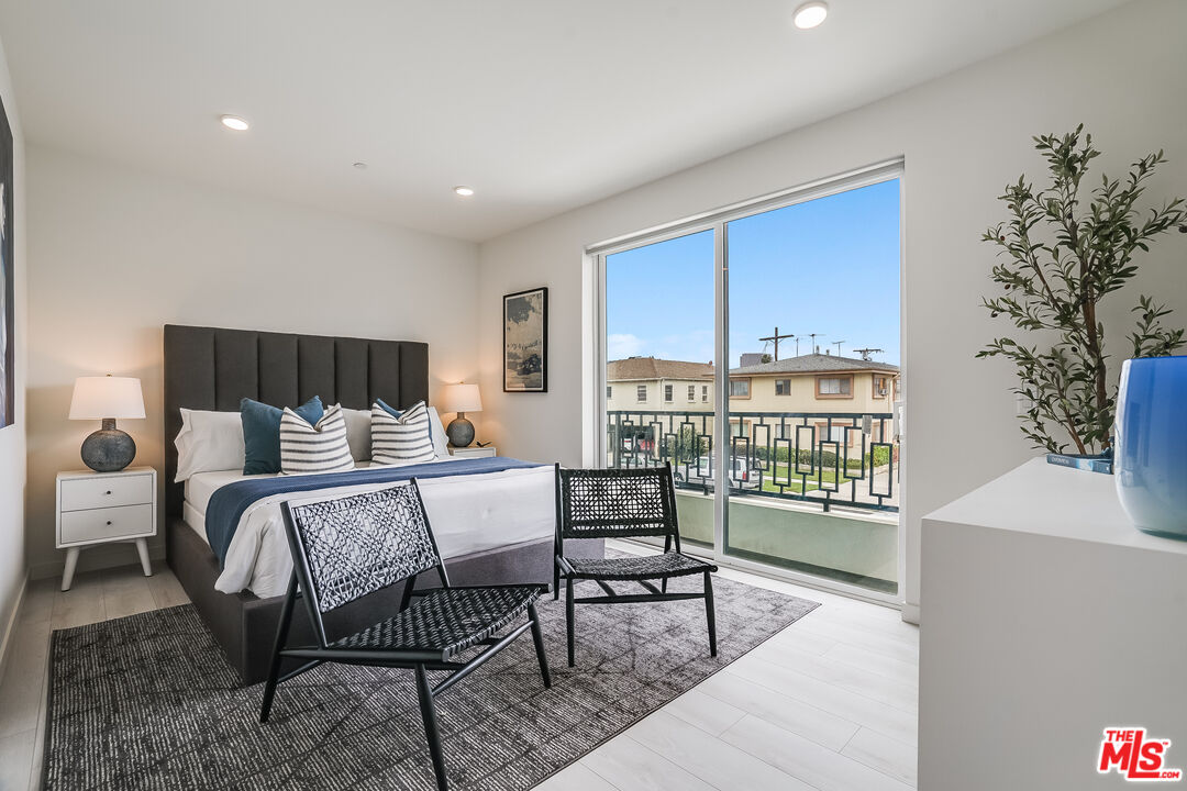 1021 South Shenandoah Street, Unit 501 Los Angeles, CA 90035 - Photo 8 of 19 a bed room with furniture and a window