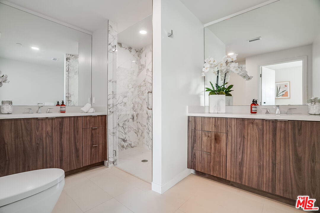 1021 South Shenandoah Street, Unit 501 Los Angeles, CA 90035 - Photo 9 of 19 a bathroom with a sink a toilet and shower