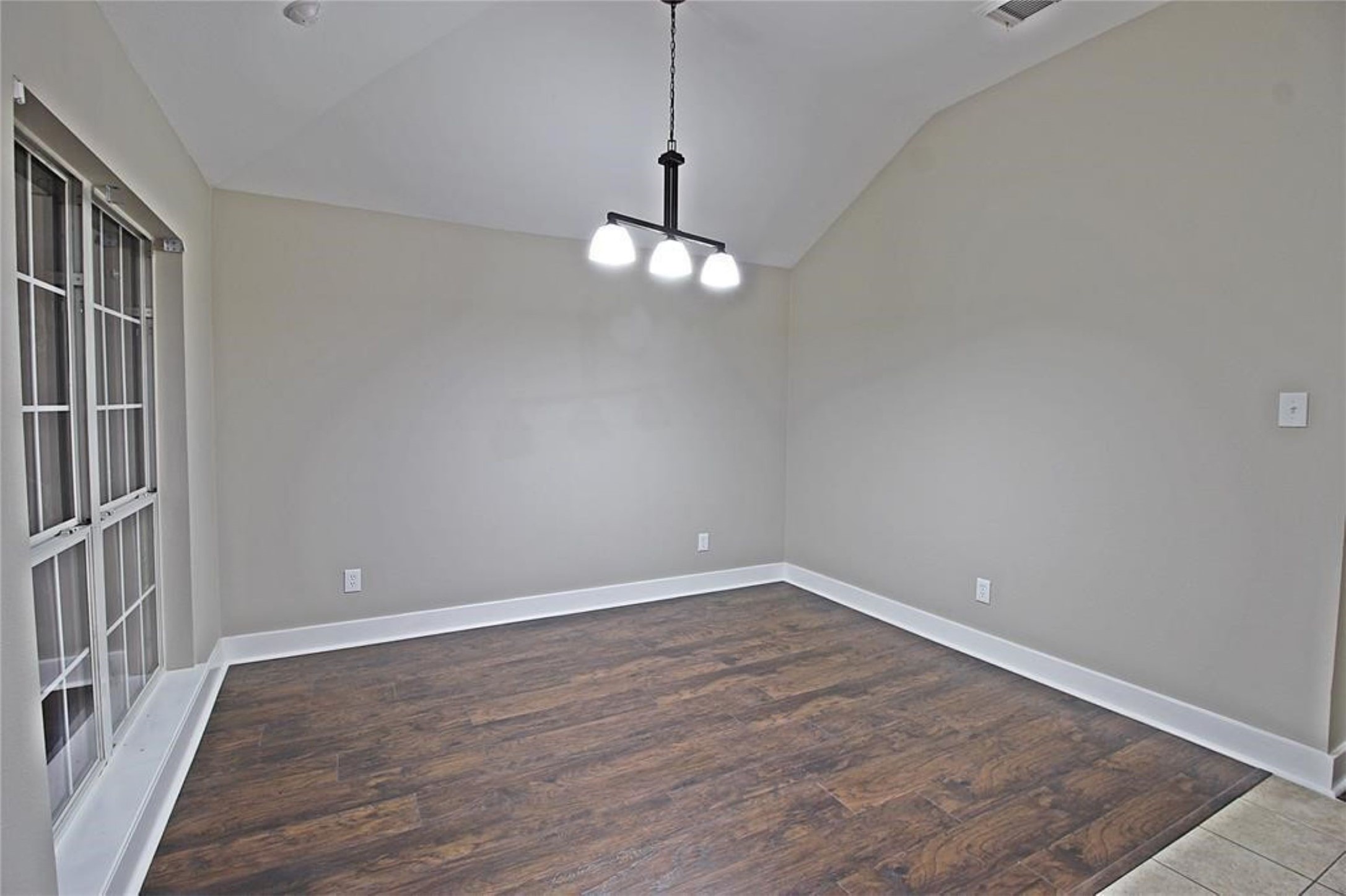 20022 Rustic Lake Lane Cypress, TX 77433 - Photo 16 of 16 a view of a room with wooden floor and white walls