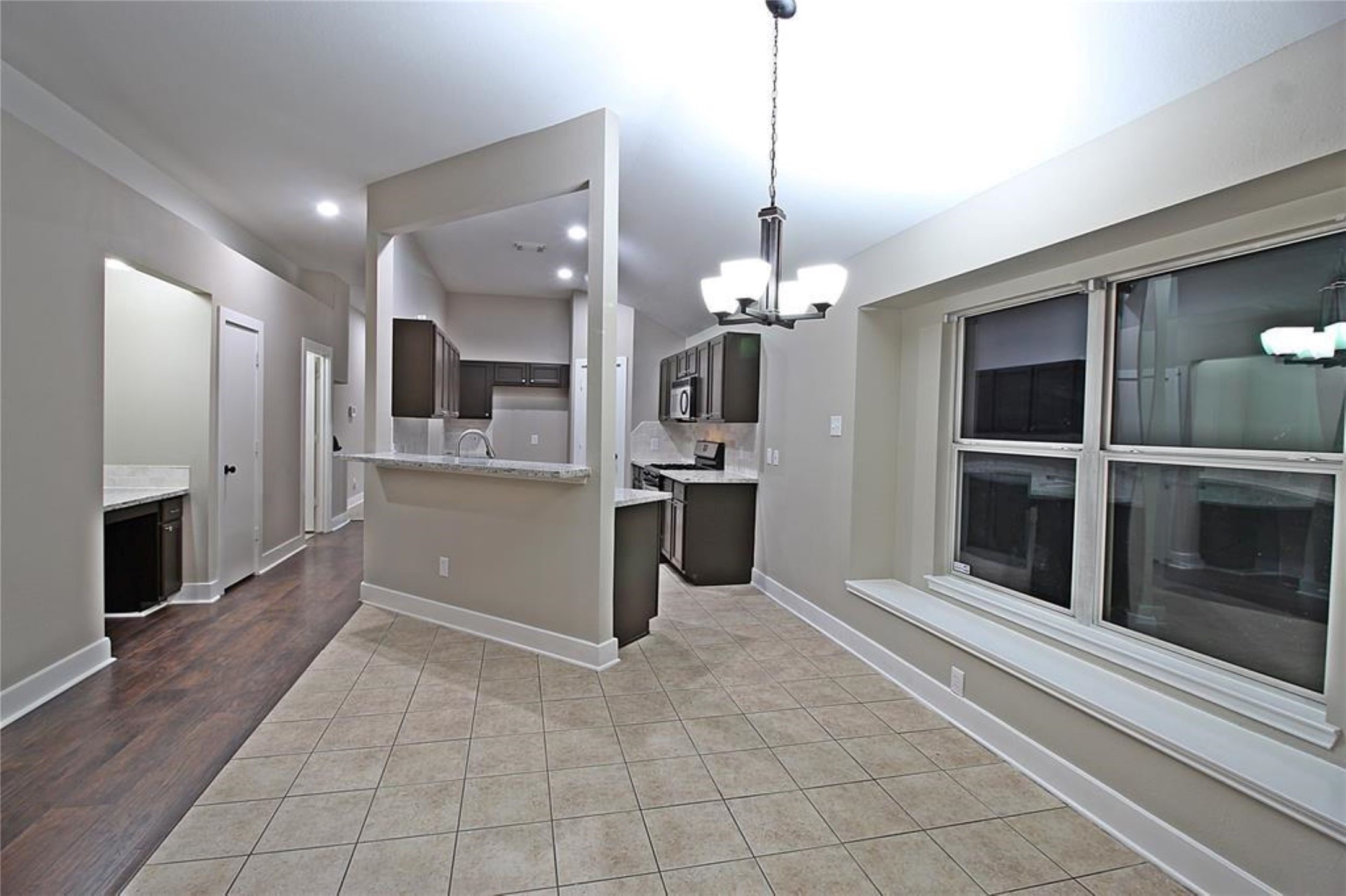 20022 Rustic Lake Lane Cypress, TX 77433 - Photo 7 of 16 a view of a kitchen with a sink and an empty room
