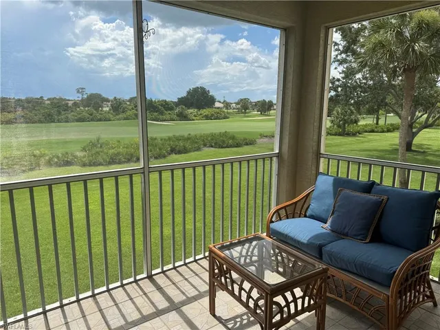 a balcony view with a couple of couches and a table