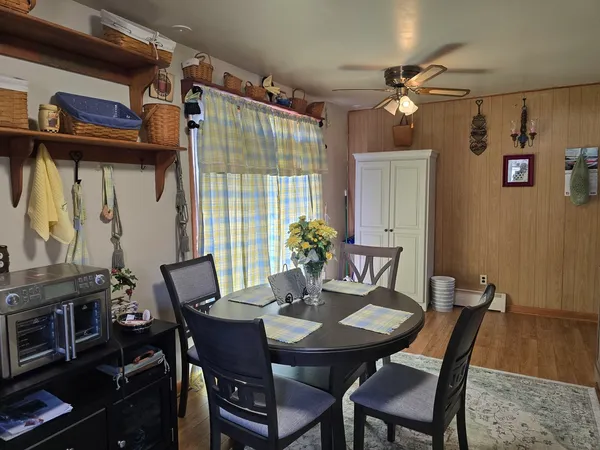 a view of a dining room with furniture and wooden floor