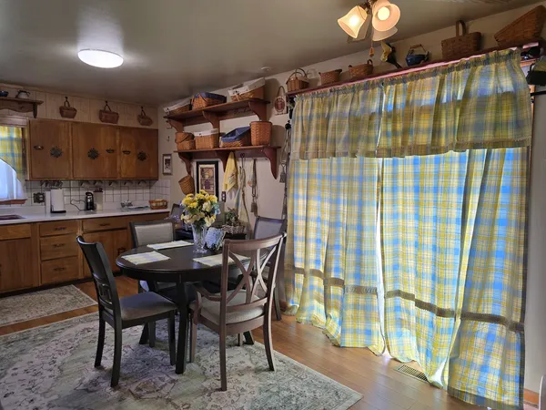 a dining room with furniture and wooden floor