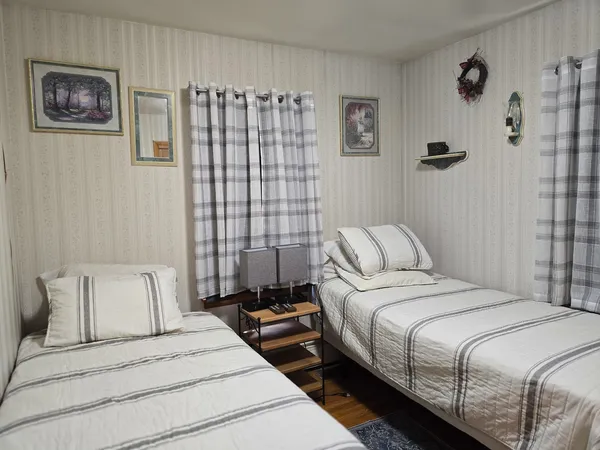 a bedroom with a bed and a painting on the wall