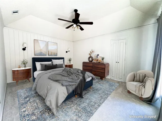 an empty room with a chandelier fan and windows
