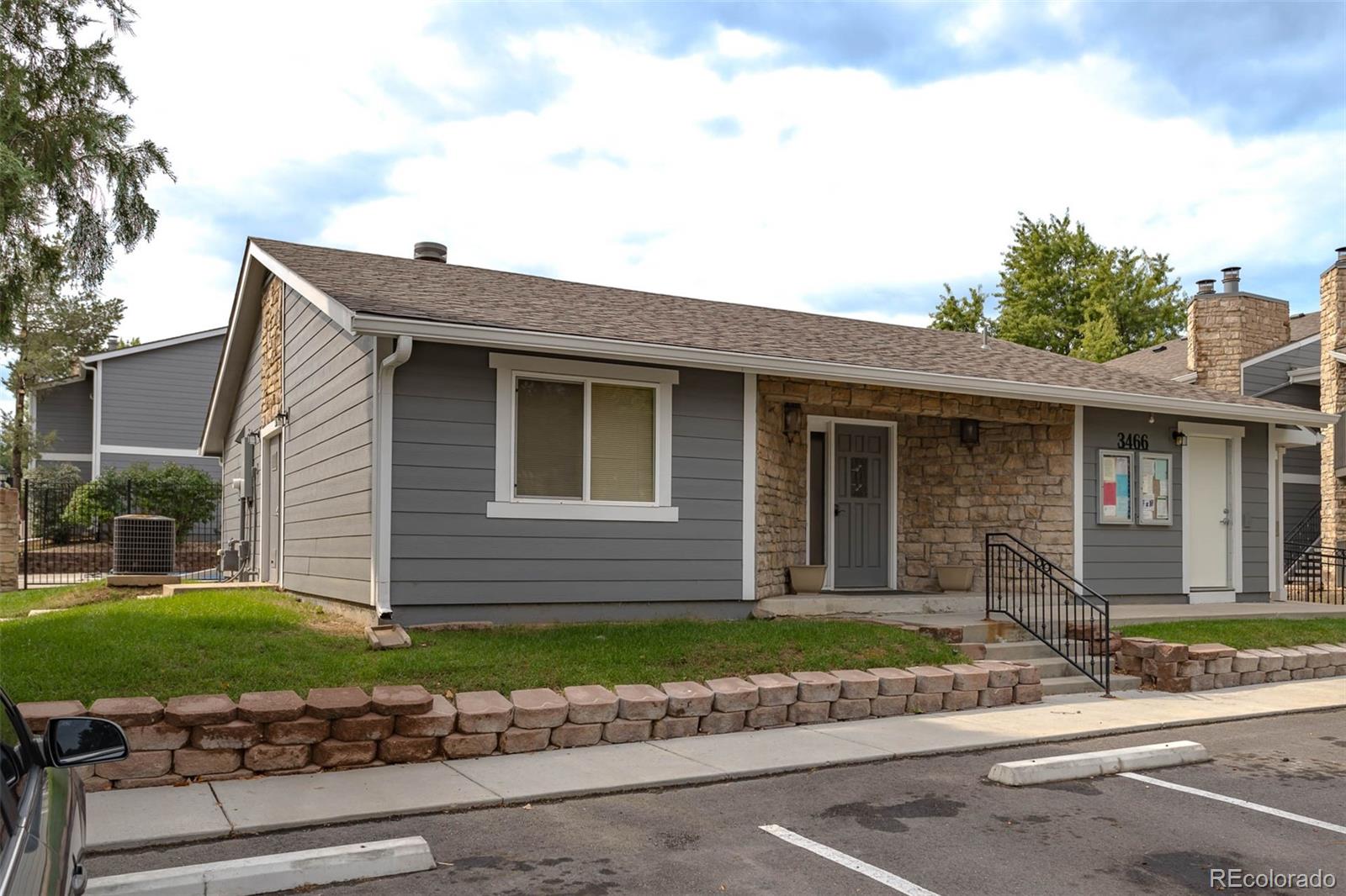 3462 South Eagle Street, Unit 201 Aurora, CO 80014 - Photo 22 of 26 a front view of a house with a yard and garage