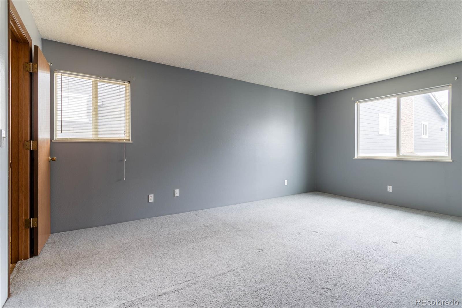 3462 South Eagle Street, Unit 201 Aurora, CO 80014 - Photo 10 of 26 an empty room with windows and closet