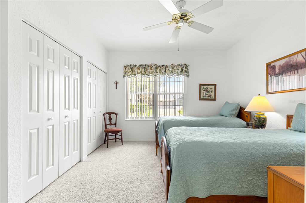 8418 Southwest 108th Pl Road Ocala, FL 34481 - Photo 20 of 80 a bedroom with a bed couch and two windows