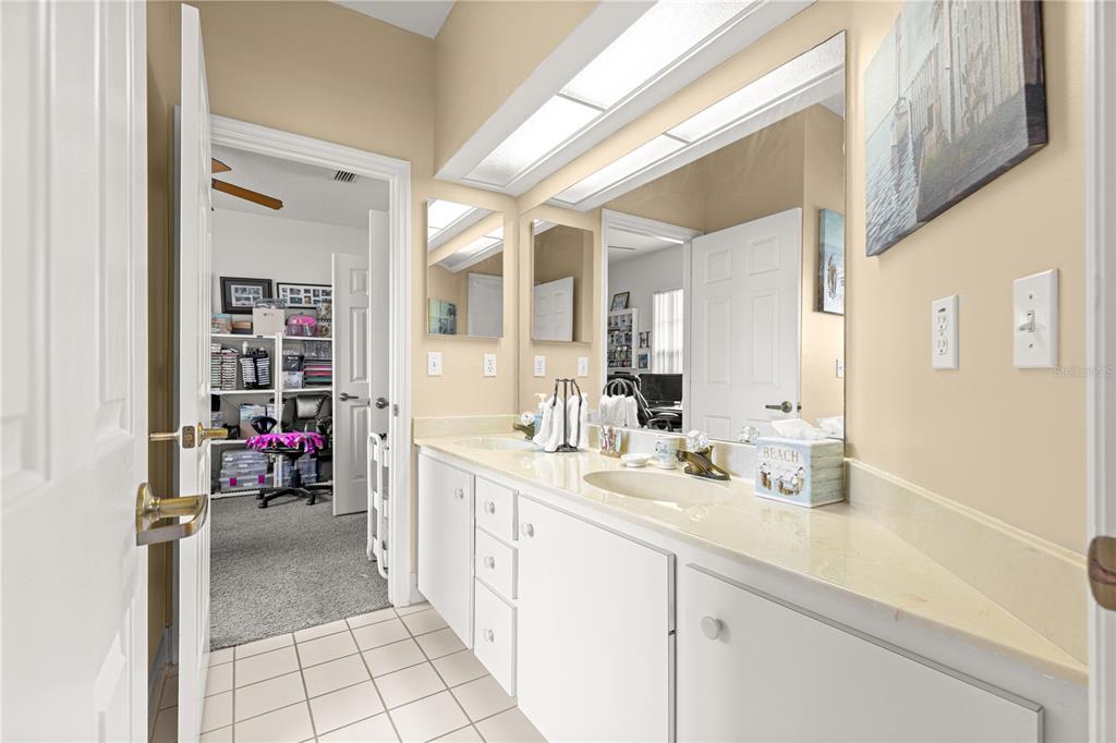 8418 Southwest 108th Pl Road Ocala, FL 34481 - Photo 22 of 80 a bathroom with a sink a mirror and a shower