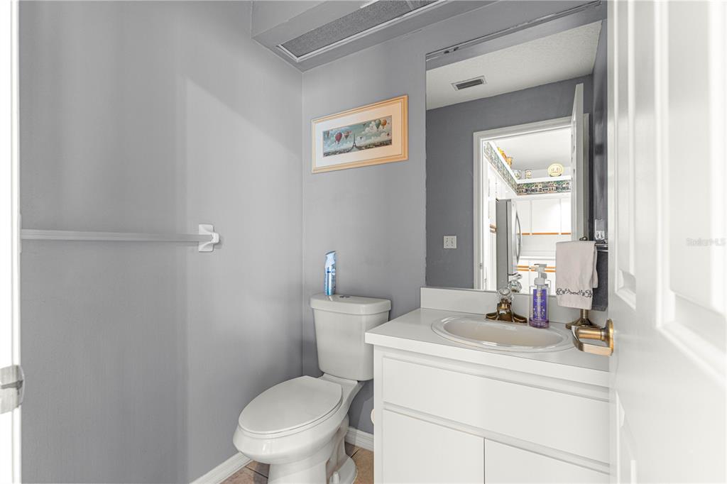 8418 Southwest 108th Pl Road Ocala, FL 34481 - Photo 38 of 80 a bathroom with a toilet a sink and a mirror