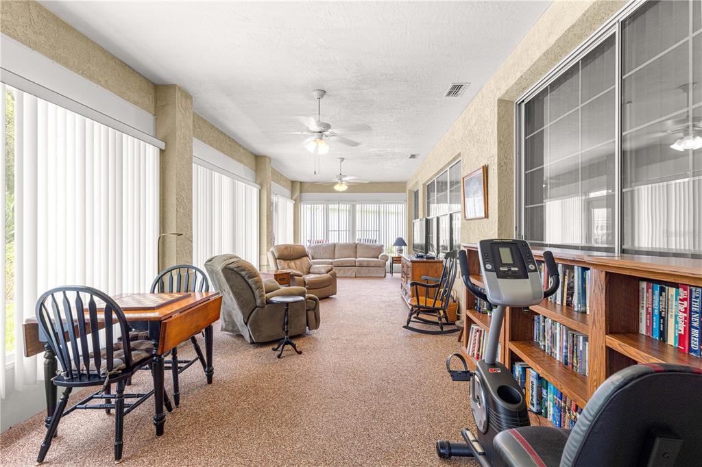 8418 Southwest 108th Pl Road Ocala, FL 34481 - Photo 41 of 80 a living room with furniture and a book shelf