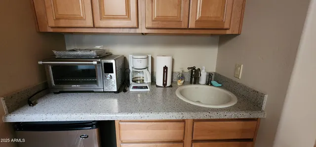 a kitchen with granite countertop a sink and cabinets