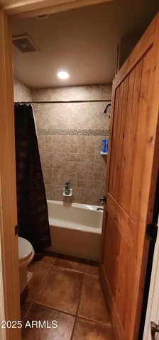 a bathroom with a bathtub and toilet