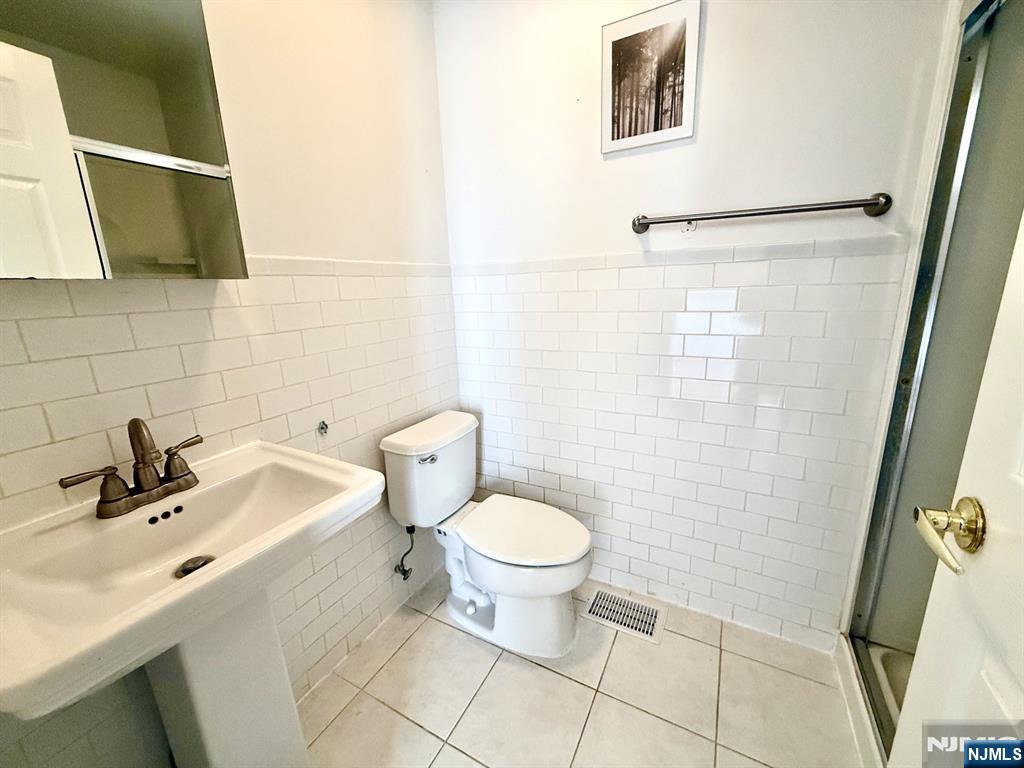 200 Dey Street, Unit 257 Harrison, NJ 07029 - Photo 12 of 21 a bathroom with a sink toilet and shower