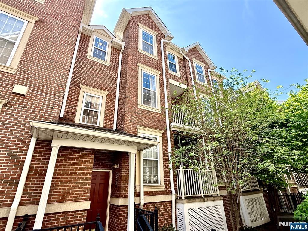 200 Dey Street, Unit 257 Harrison, NJ 07029 - Photo 2 of 21 a front view of a house with a yard