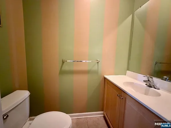 a bathroom with a sink and mirror with toilet