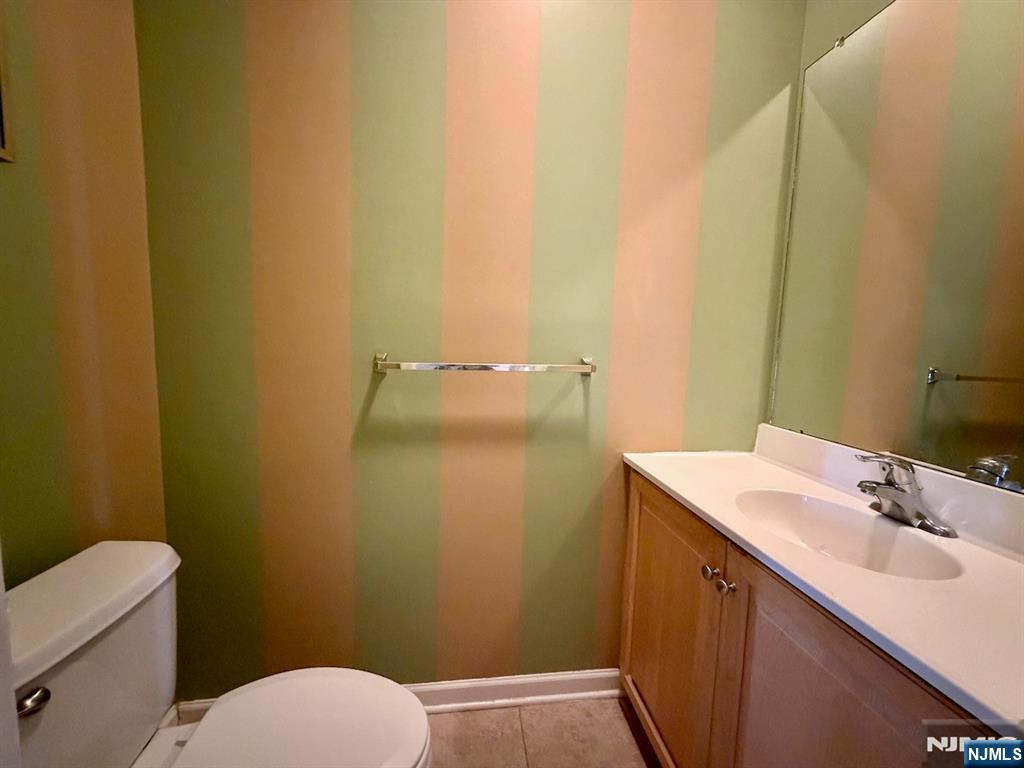 200 Dey Street, Unit 257 Harrison, NJ 07029 - Photo 7 of 21 a bathroom with a sink and mirror with toilet