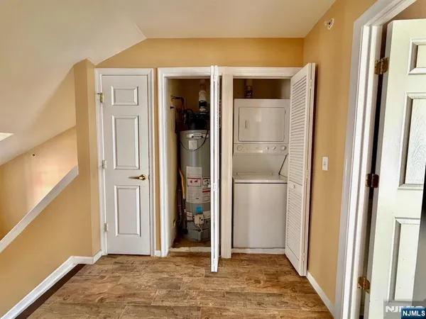 a view of a hallway with wooden floor and entryway