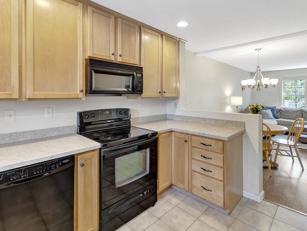 13 Shawmut Avenue, Unit 13 Mansfield, MA 02048 - Photo 12 of 34 a kitchen with cabinets appliances and a counter top space
