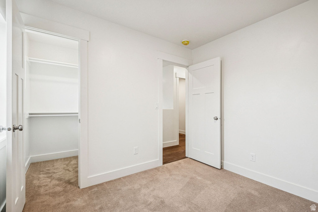 1627 North Angel Street Layton, UT 84041 - Photo 6 of 39 Unfurnished bedroom featuring light colored carpet and a spacious closet