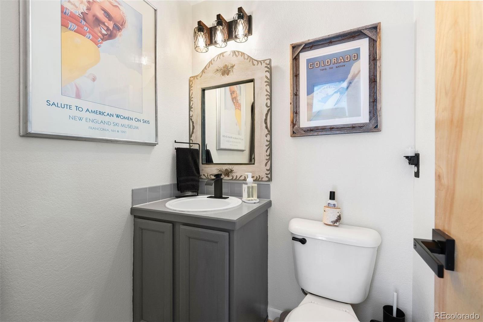 29895 Spruce Road Evergreen, CO 80439 - Photo 16 of 38 a bathroom with a toilet sink and mirror