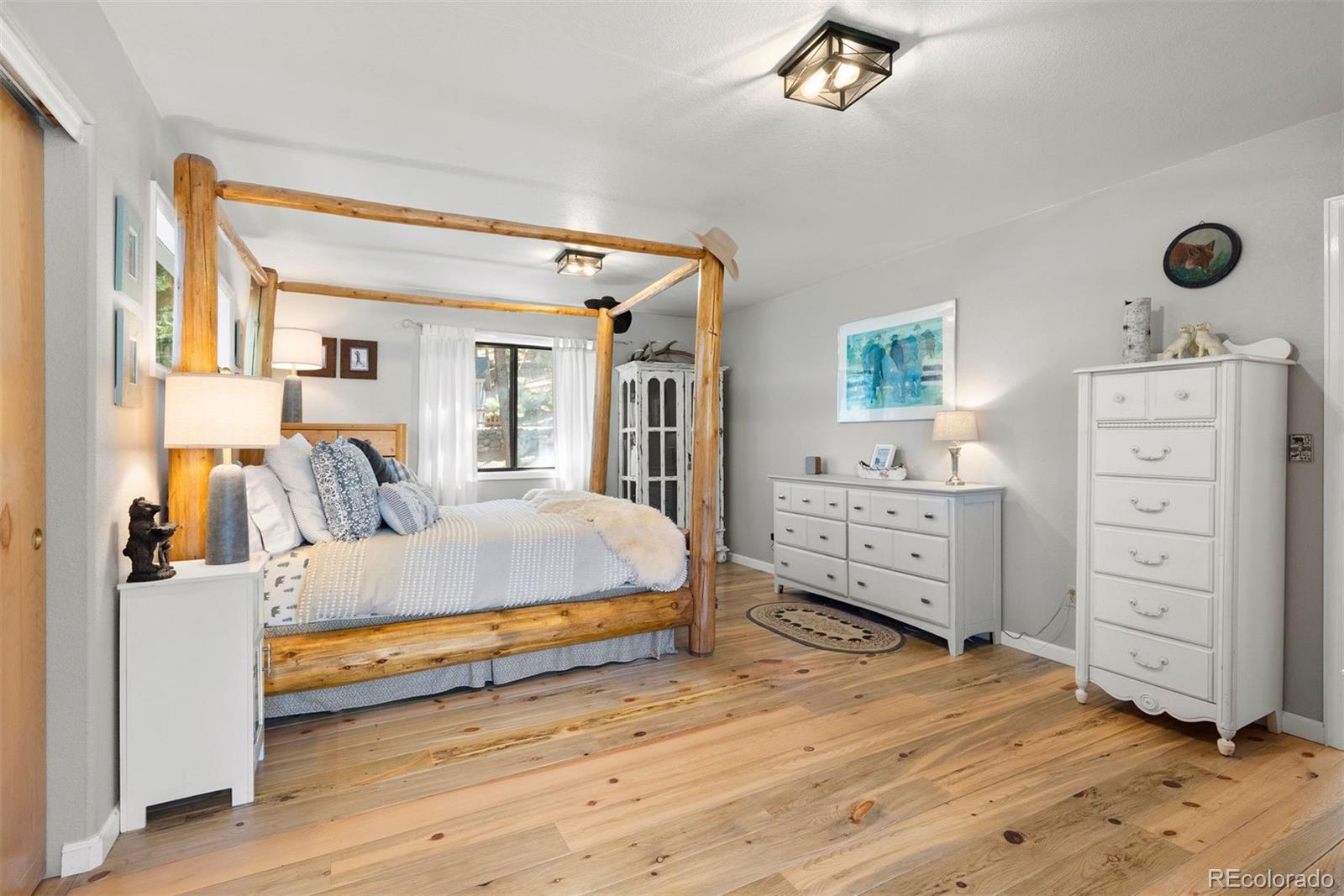 29895 Spruce Road Evergreen, CO 80439 - Photo 18 of 38 a spacious bedroom with a bed and a cabinets