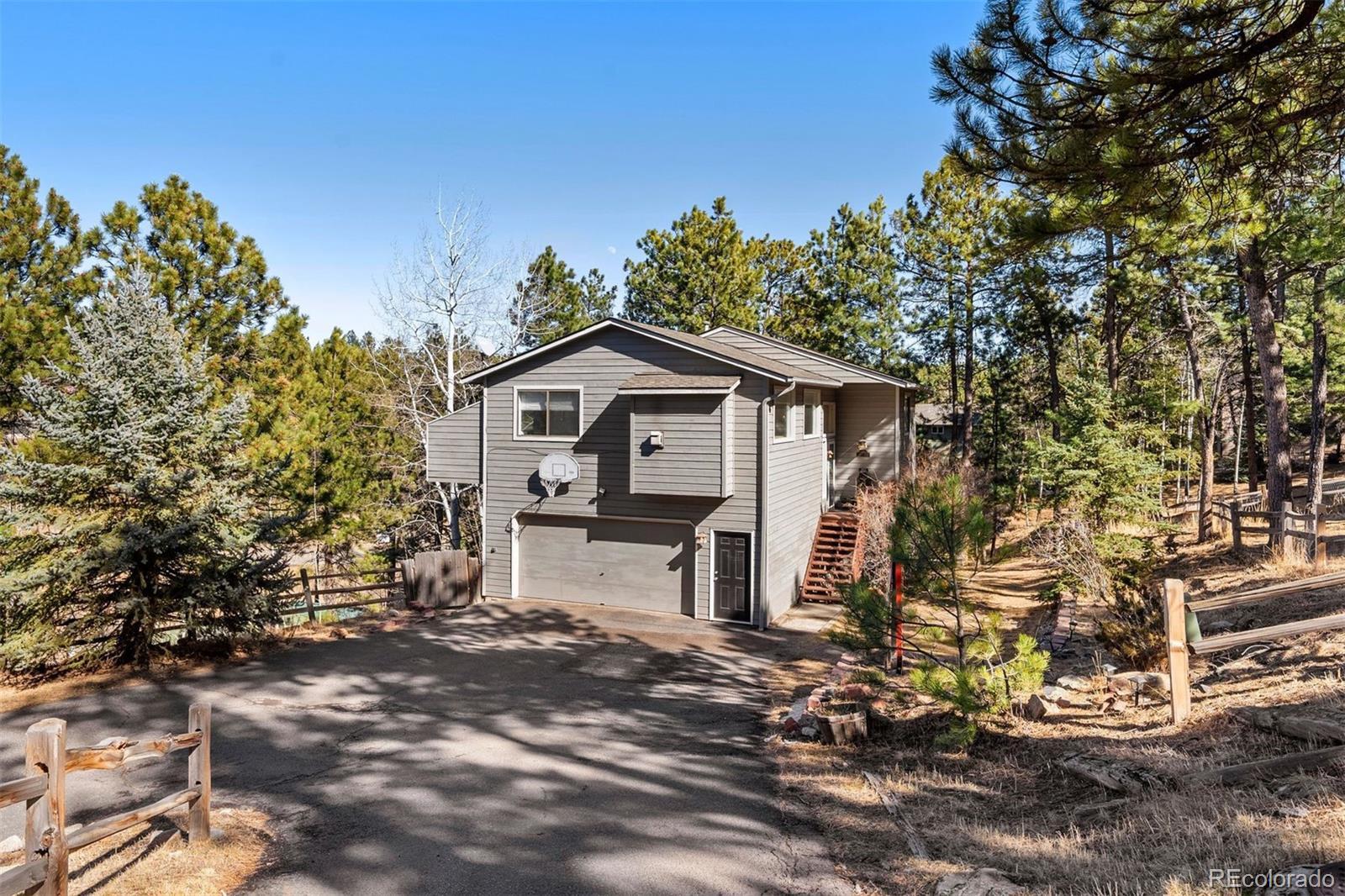 29895 Spruce Road Evergreen, CO 80439 - Photo 2 of 38 a view of a house with a yard