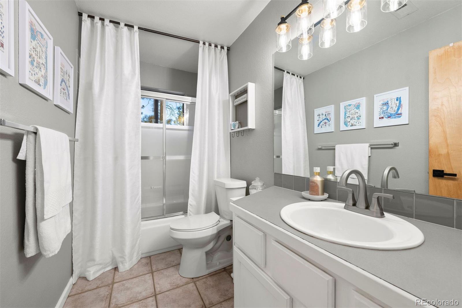 29895 Spruce Road Evergreen, CO 80439 - Photo 29 of 38 a bathroom with a sink toilet and shower