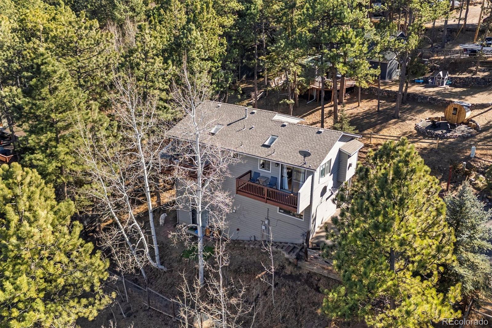 29895 Spruce Road Evergreen, CO 80439 - Photo 3 of 38 an aerial view of a house with a yard