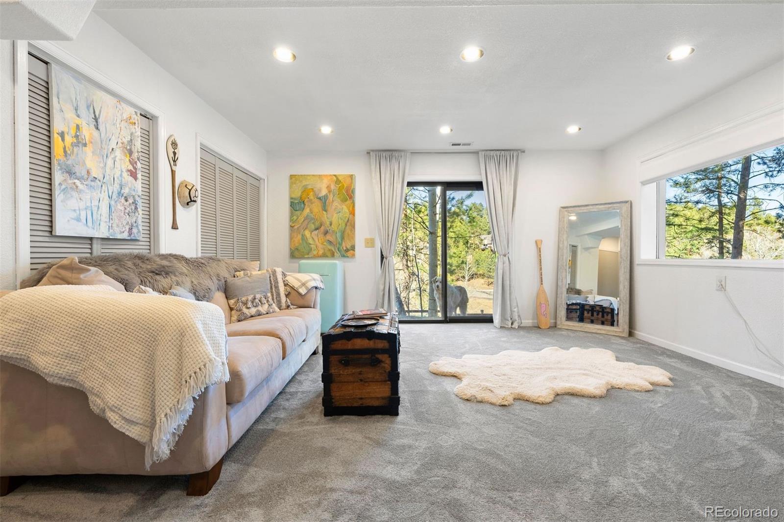 29895 Spruce Road Evergreen, CO 80439 - Photo 31 of 38 a spacious bedroom with a large bed and a large window