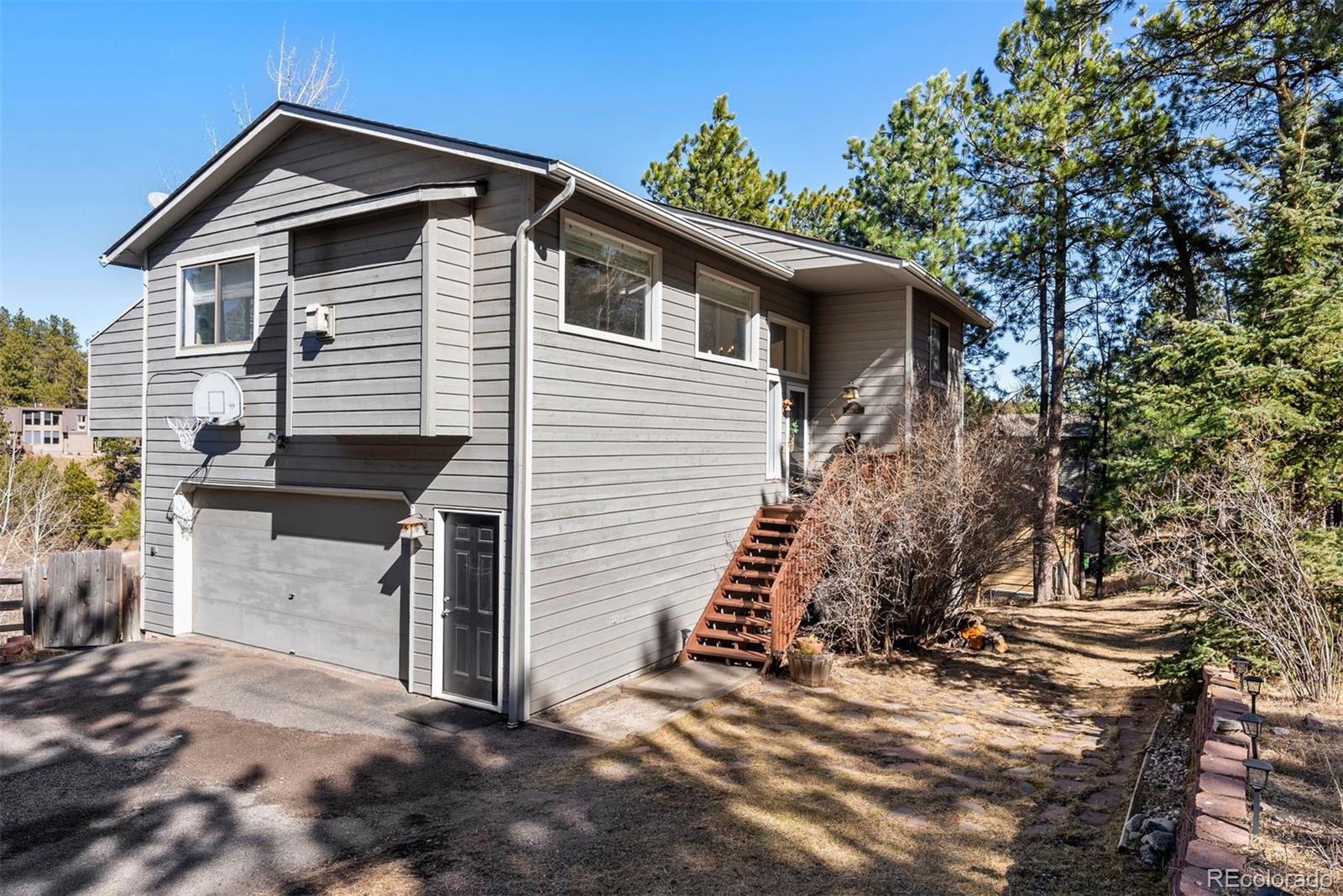 29895 Spruce Road Evergreen, CO 80439 - Photo 37 of 38 a view of a house with a yard