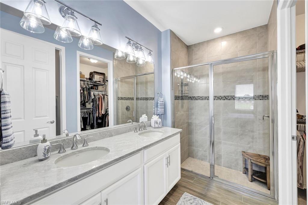1261 Enbrook Loop Naples, FL 34114 - Photo 11 of 23 a bathroom with a double vanity sink and a mirror