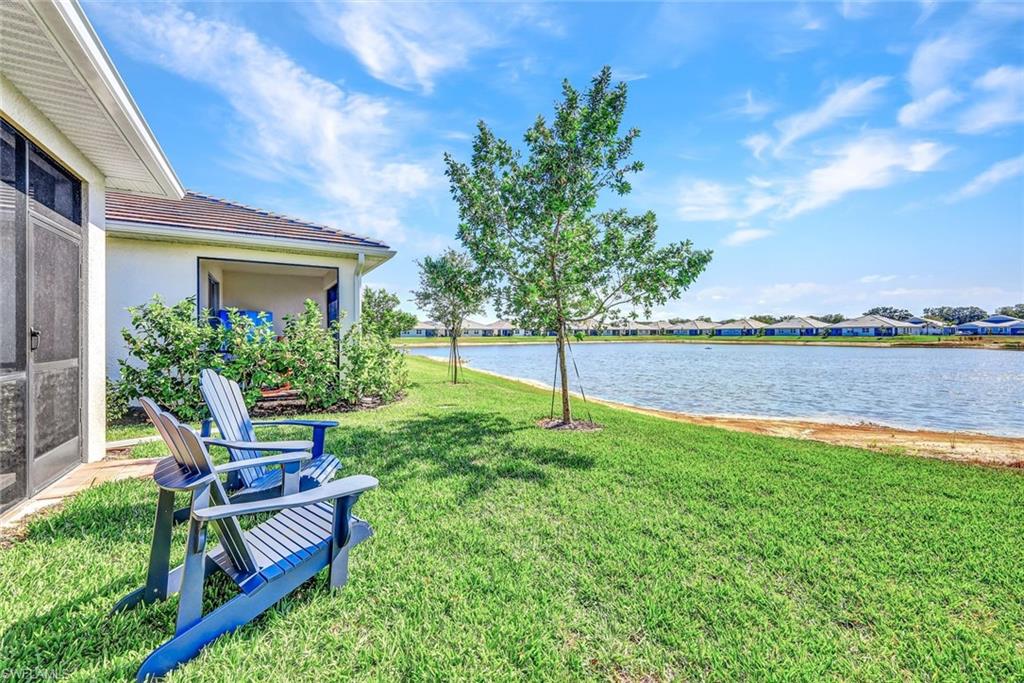 1261 Enbrook Loop Naples, FL 34114 - Photo 19 of 23 a backyard of a house with table and chairs