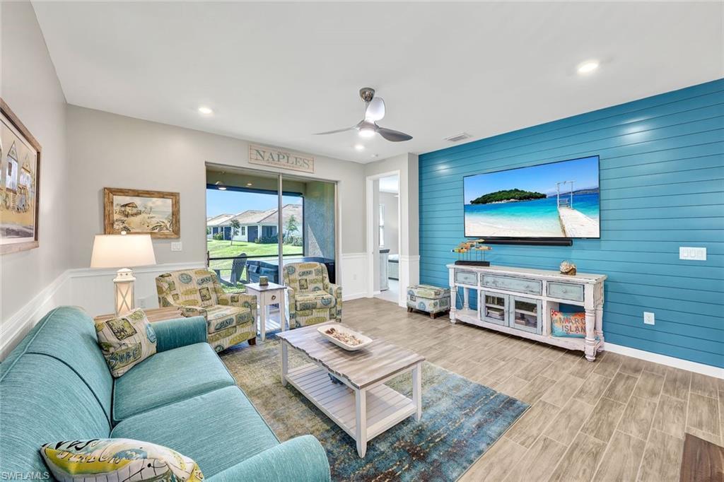 1261 Enbrook Loop Naples, FL 34114 - Photo 4 of 23 a living room with furniture and a flat screen tv