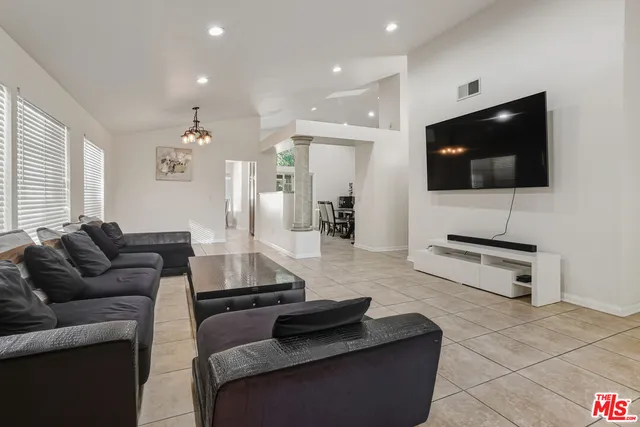a living room with furniture and a flat screen tv