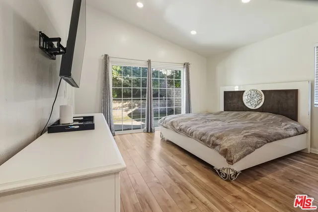 a bedroom with a bed and a large window