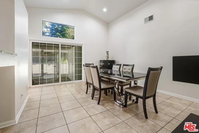 a view of a dining room with furniture and a floor to ceiling window