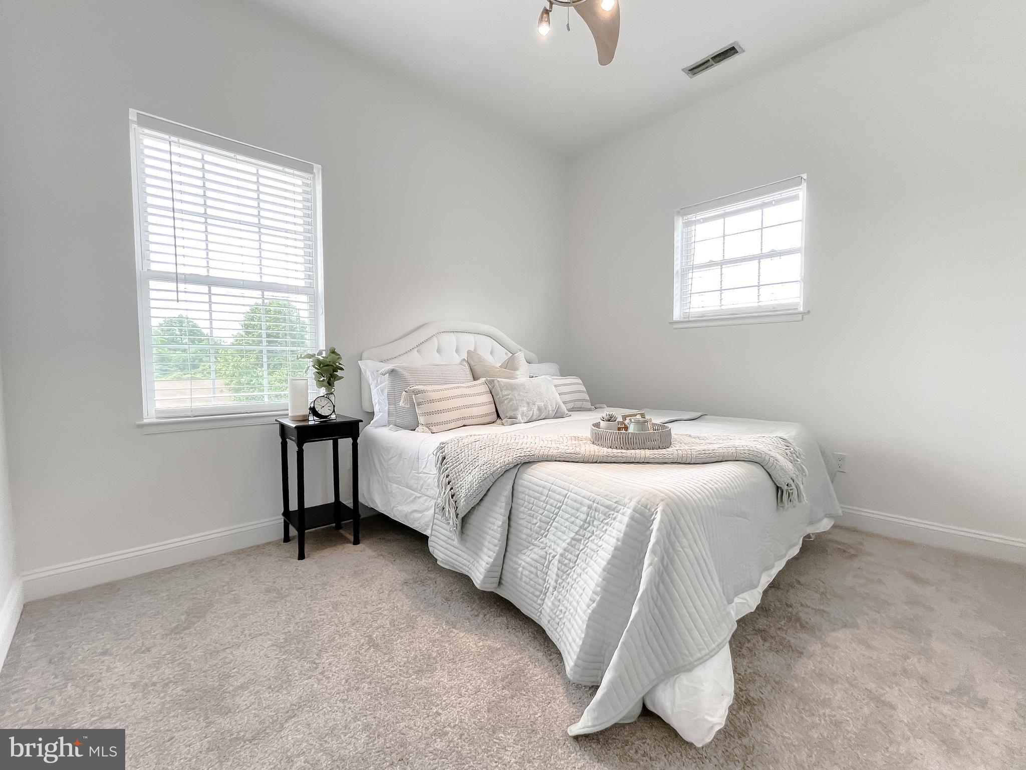 48673 Trapp Road St. Inigoes, MD 20684 - Photo 13 of 39 a bedroom with a bed and a window