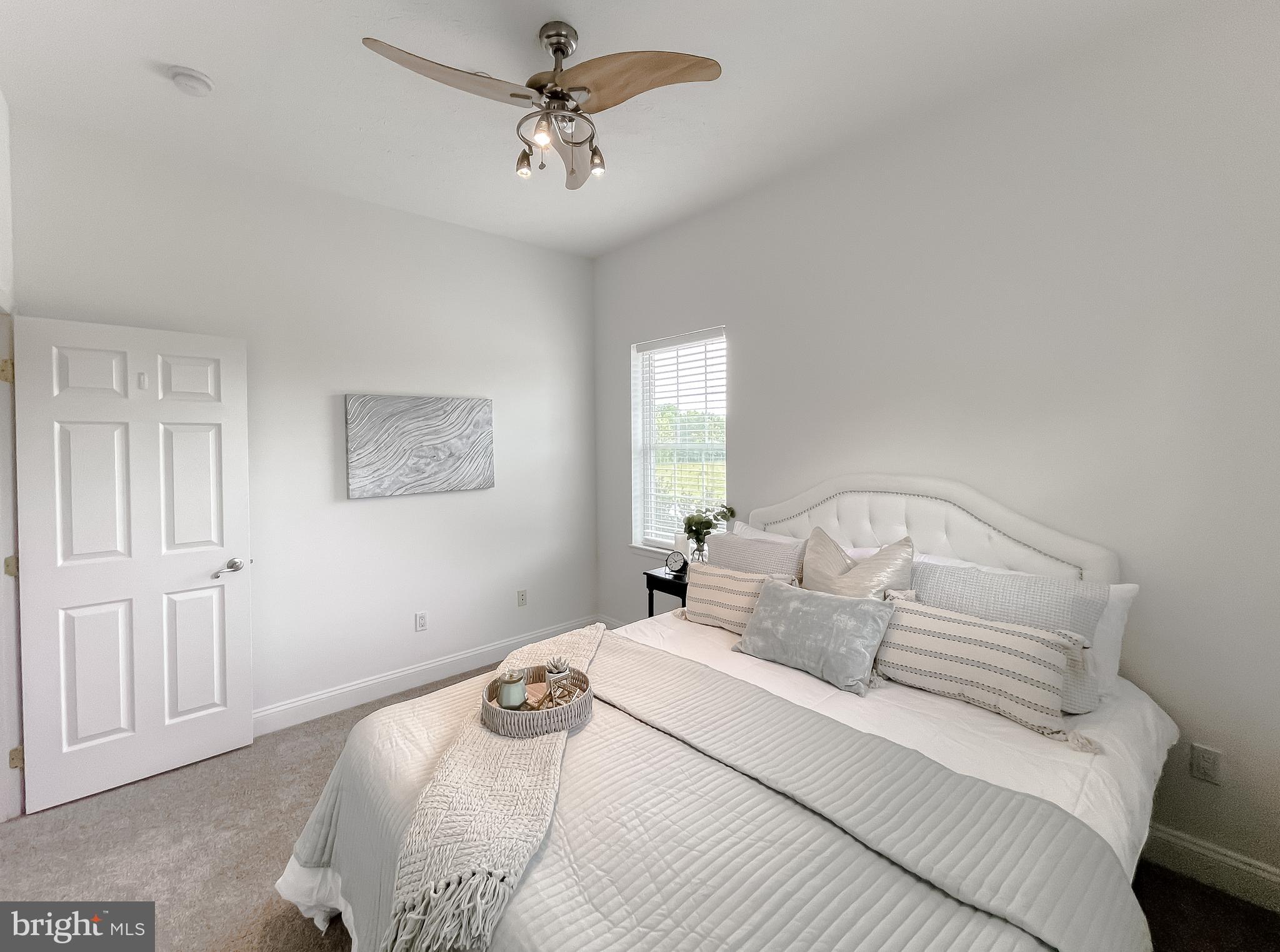 48673 Trapp Road St. Inigoes, MD 20684 - Photo 14 of 39 a bedroom with a bed and a chandelier