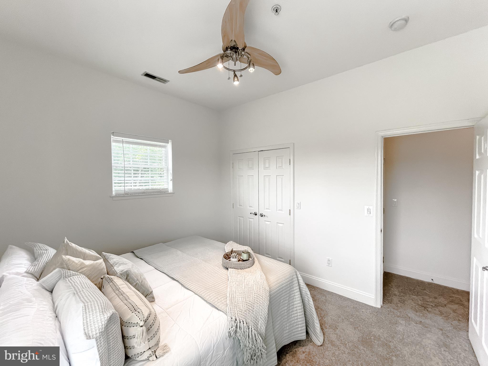 48673 Trapp Road St. Inigoes, MD 20684 - Photo 15 of 39 a bedroom with a bed and a chandelier