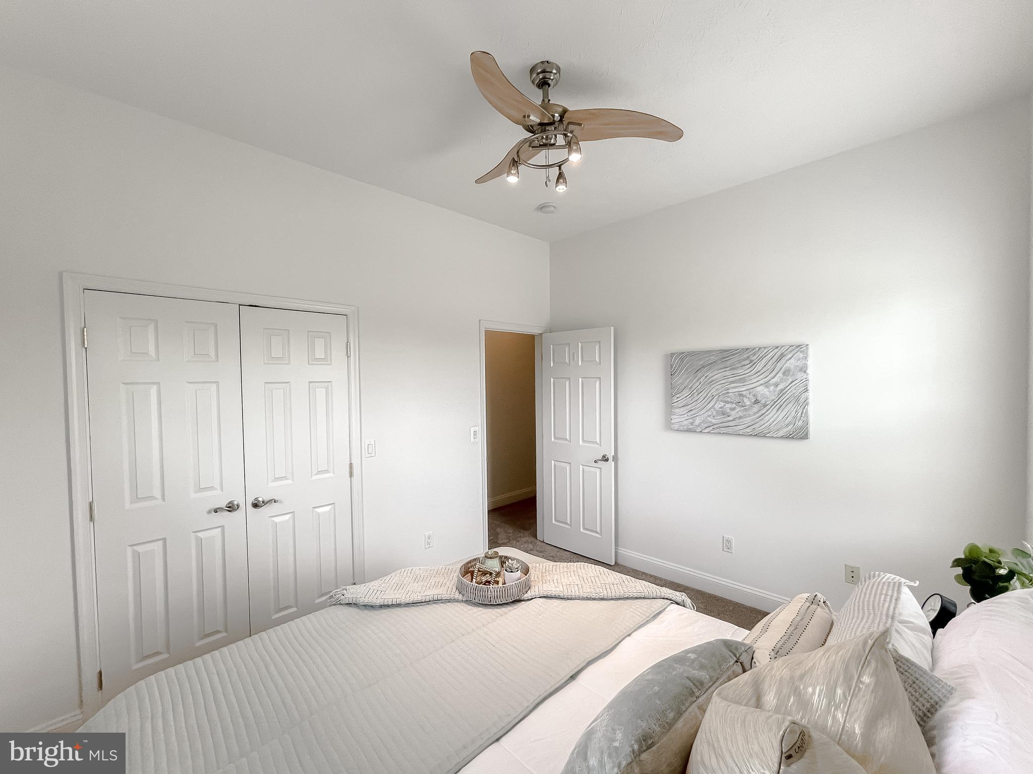 48673 Trapp Road St. Inigoes, MD 20684 - Photo 16 of 39 a bedroom that has a bed and a chandelier